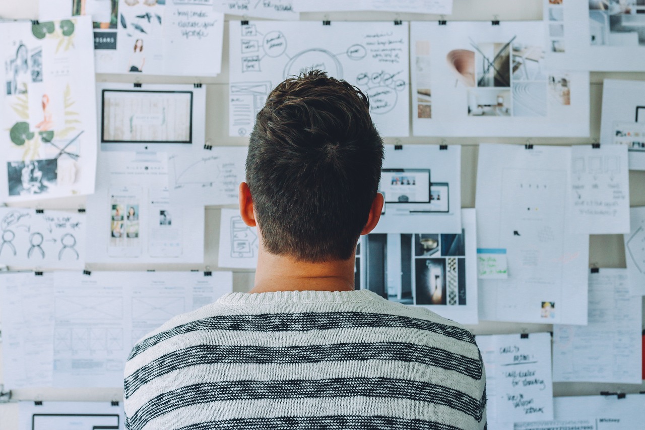 Employee looking at a board with complex documents